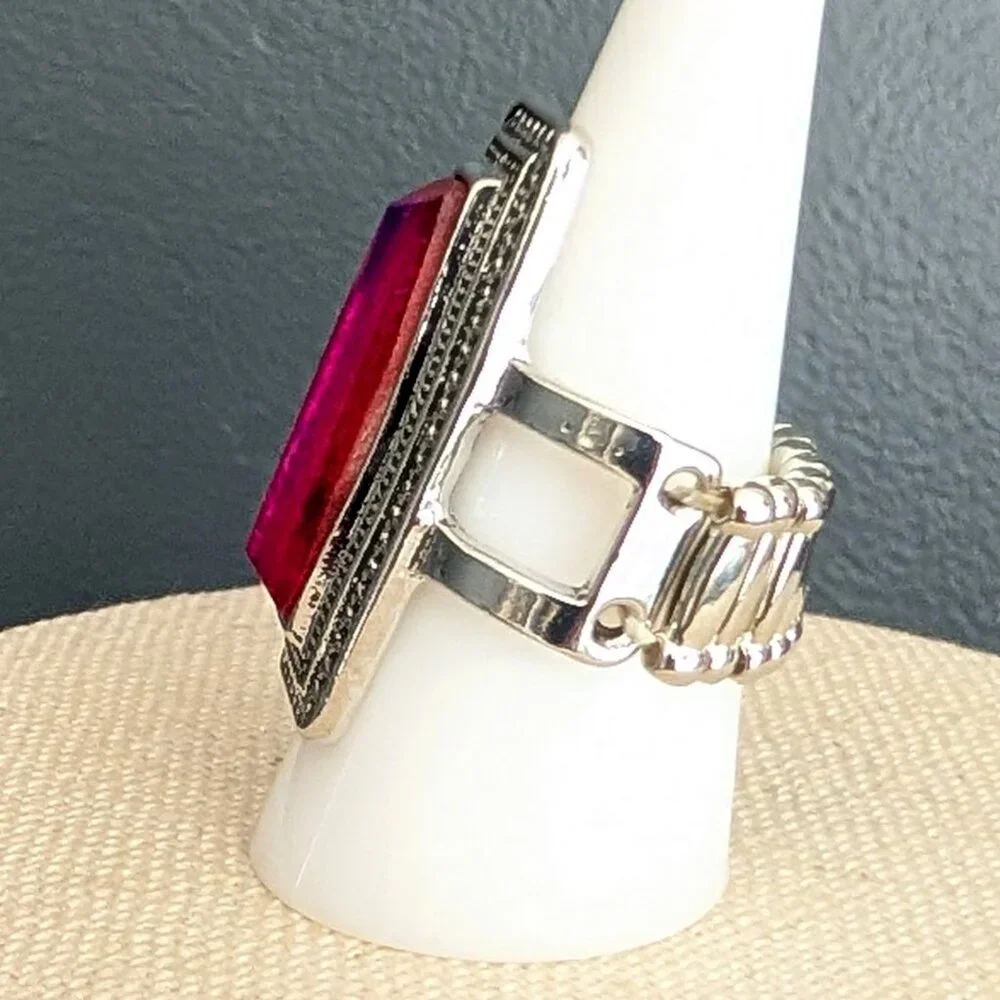 Orangey red glass ring with center bright blue stripe stretch ring